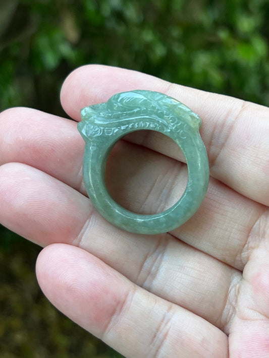 Hand holding a Size US 12.5 certified Grade A Burmese jadeite ring featuring a bold hand-carved dragon motif in icy green, item JDR007