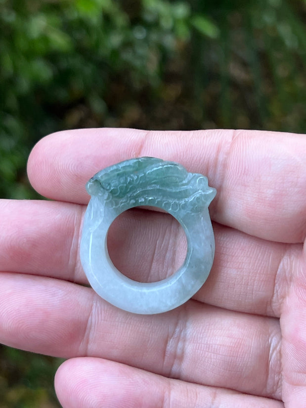 Hand holding a Size US 8 certified Grade A Burmese jadeite ring featuring a hand-carved dragon motif in icy white and vivid green, item JDR008