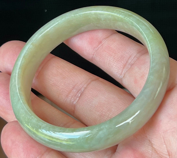 Close-up of fine crystalline texture on icy apple green jadeite bangle