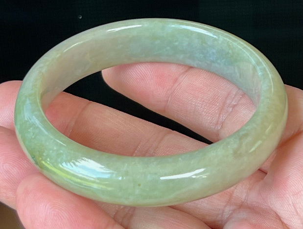 Close-up of fine crystalline texture on icy apple green jadeite bangle