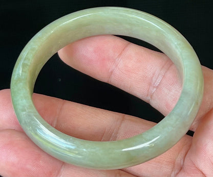 Close-up of fine crystalline texture on icy apple green jadeite bangle
