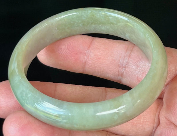Close-up of fine crystalline texture on icy apple green jadeite bangle