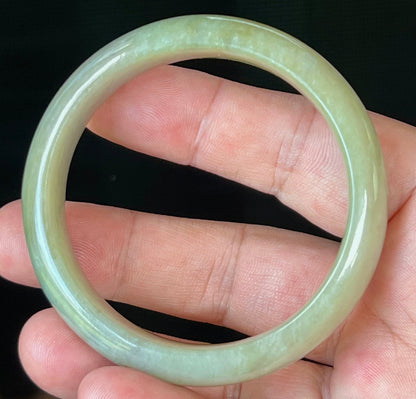 Close-up of fine crystalline texture on icy apple green jadeite bangle