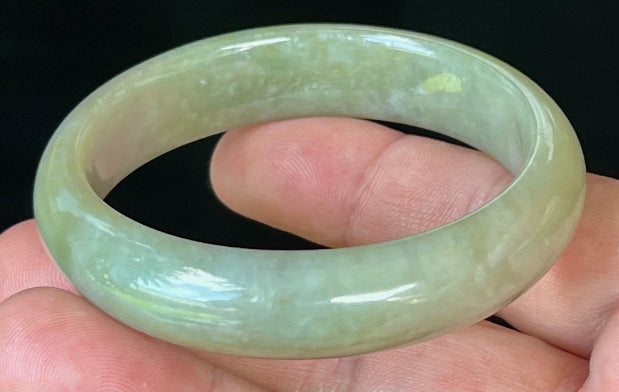 Close-up of fine crystalline texture on icy apple green jadeite bangle