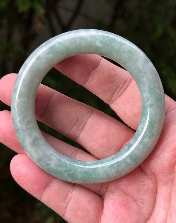 Close-up of icy celadon and mint green hues on Burmese jadeite bangle