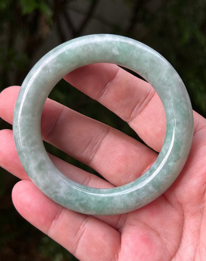 Close-up of icy celadon and mint green hues on Burmese jadeite bangle
