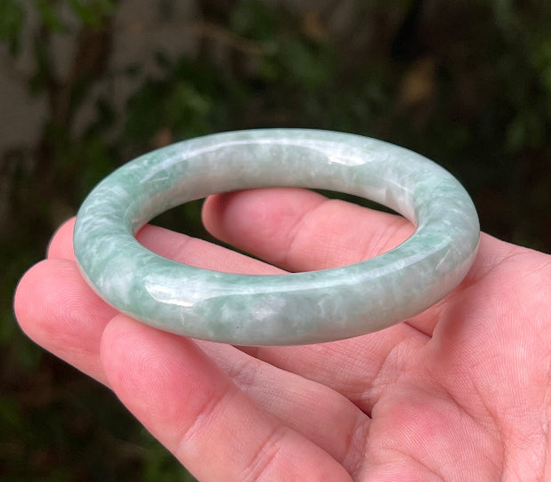Close-up of icy celadon and mint green hues on Burmese jadeite bangle