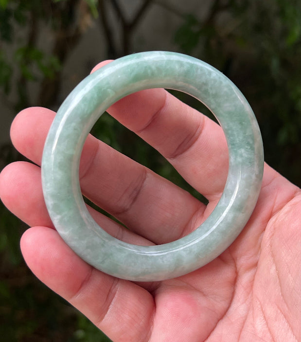 Close-up of icy celadon and mint green hues on Burmese jadeite bangle