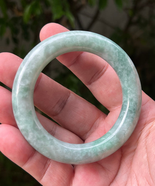 Close-up of icy celadon and mint green hues on Burmese jadeite bangle