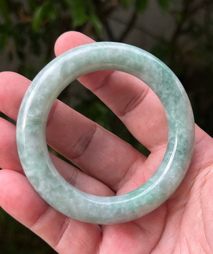 Close-up of icy celadon and mint green hues on Burmese jadeite bangle