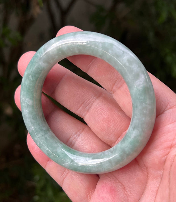 Close-up of icy celadon and mint green hues on Burmese jadeite bangle