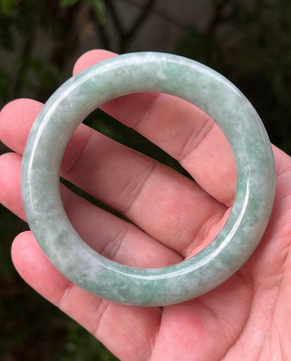 Close-up of icy celadon and mint green hues on Burmese jadeite bangle