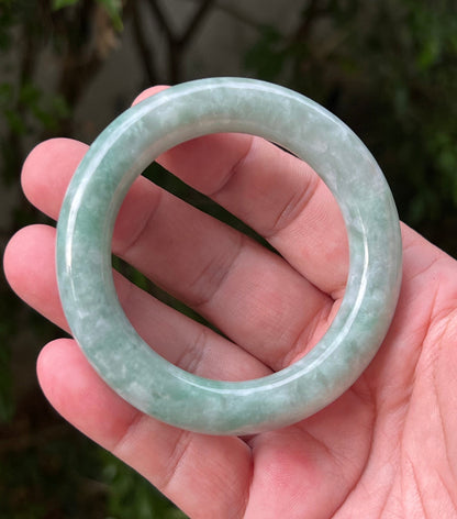 Close-up of icy celadon and mint green hues on Burmese jadeite bangle