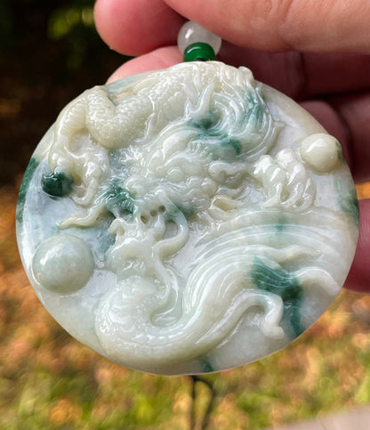 Untreated Type A Burmese jade pendant showing translucent luster with beautiful imperial green and white colors on an adjustable cord