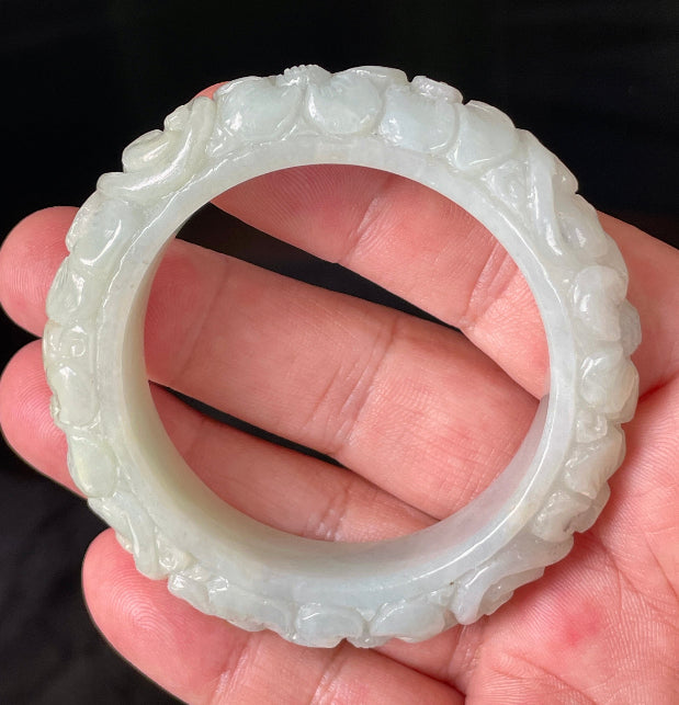 Handcrafted genuine Grade A Burmese jadeite bracelet showcasing a beautiful green floral appearance and certification