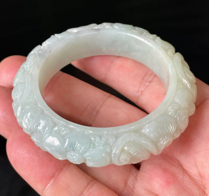 Handcrafted genuine Grade A Burmese jadeite bracelet showcasing a beautiful green floral appearance and certification