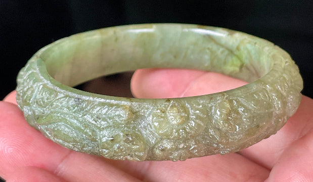 Handcrafted genuine Grade A Burmese jadeite bracelet showcasing a beautiful green floral appearance and certification