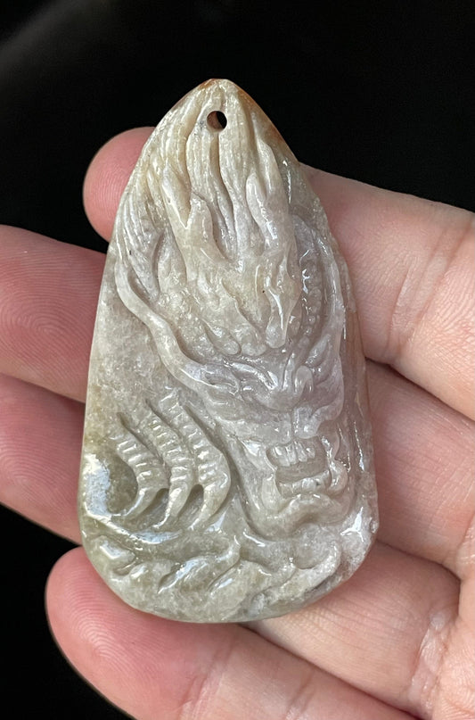 Close-up of a certified natural Grade A Burmese jadeite pendant featuring icy light greyish brown and honey-orange hues hand-carved in a double-sided dragon and fish motif, item JP070