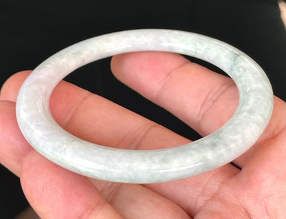 Solid icy white and apple green natural Type A Burmese jade bangle bracelet in a flat round style, size 56.5mm