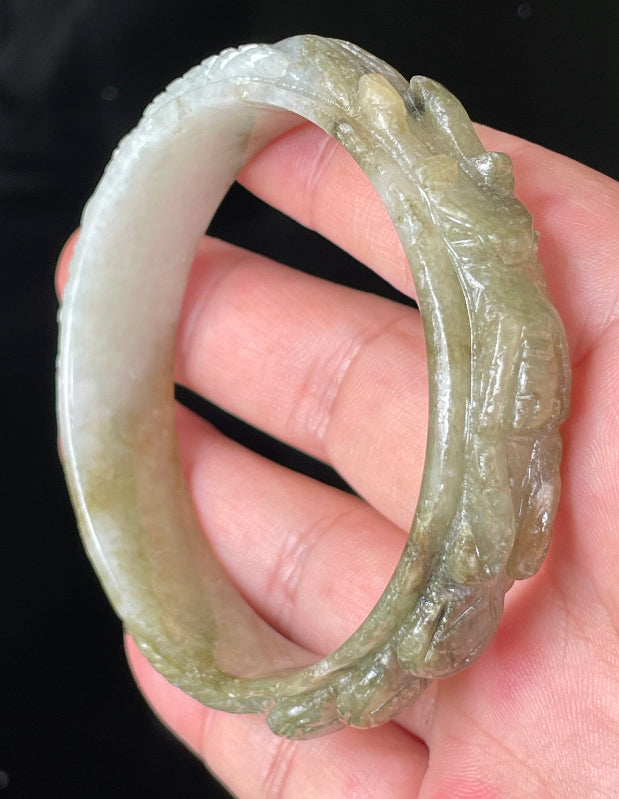 Solid icy green and milky white natural Type A Burmese jade bangle bracelet with carved dragon design, size 58.9mm