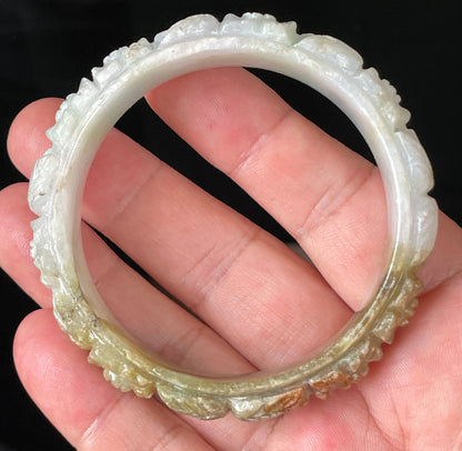 Solid icy forest green and honey orange natural Type A Burmese jade bangle bracelet with carved floral design, size 58.7mm