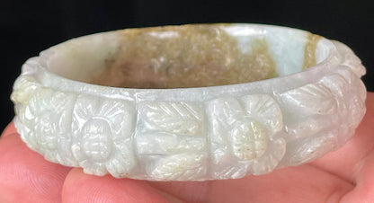 Solid icy forest green and honey orange natural Type A Burmese jade bangle bracelet with carved floral design, size 58.7mm