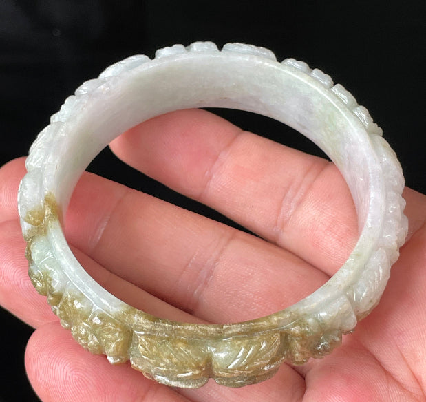 Solid icy forest green and honey orange natural Type A Burmese jade bangle bracelet with carved floral design, size 58.7mm