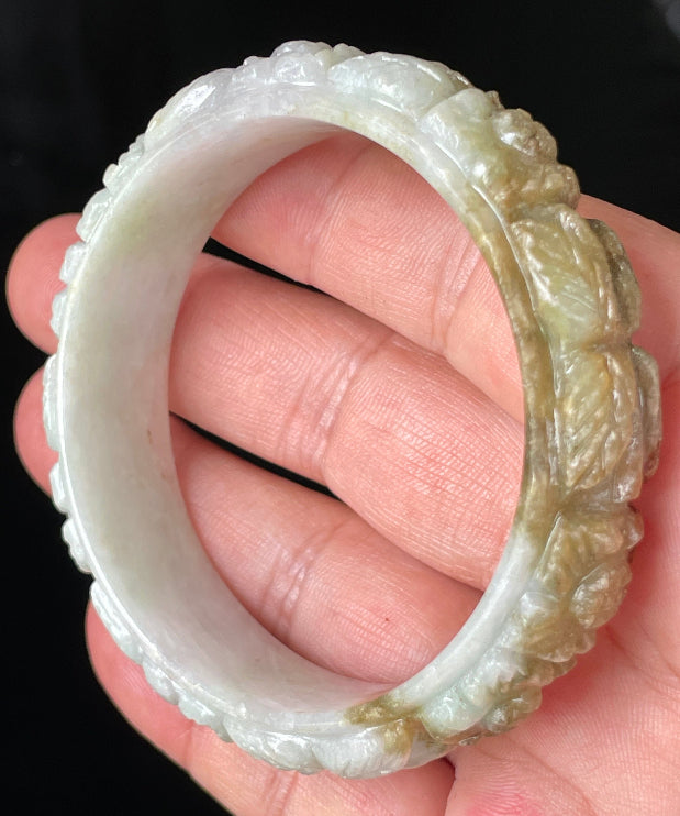 Solid icy forest green and honey orange natural Type A Burmese jade bangle bracelet with carved floral design, size 58.7mm