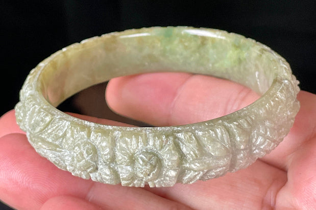 Solid icy apple green and milky white natural Type A Burmese jade bangle bracelet with carved floral design, size 57.4mm