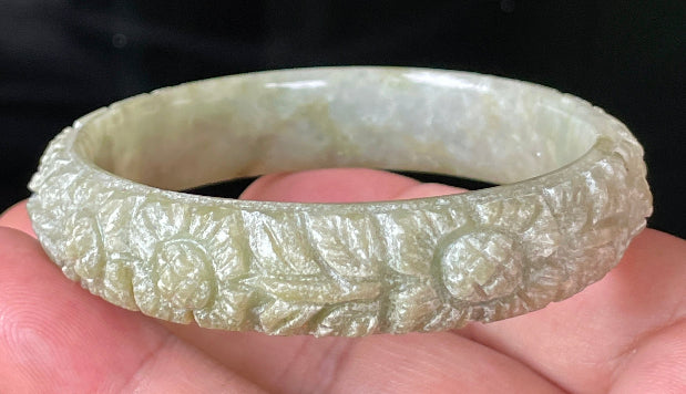 Solid icy apple green and milky white natural Type A Burmese jade bangle bracelet with carved floral design, size 57.4mm