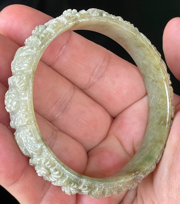 Solid icy apple green and milky white natural Type A Burmese jade bangle bracelet with carved floral design, size 57.4mm