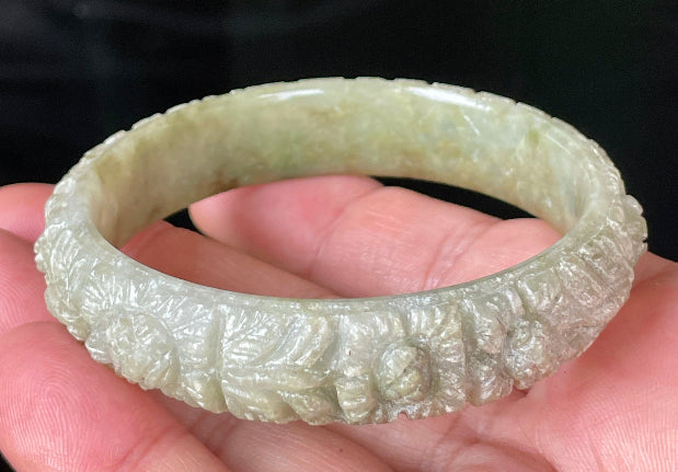 Solid icy apple green and milky white natural Type A Burmese jade bangle bracelet with carved floral design, size 57.4mm