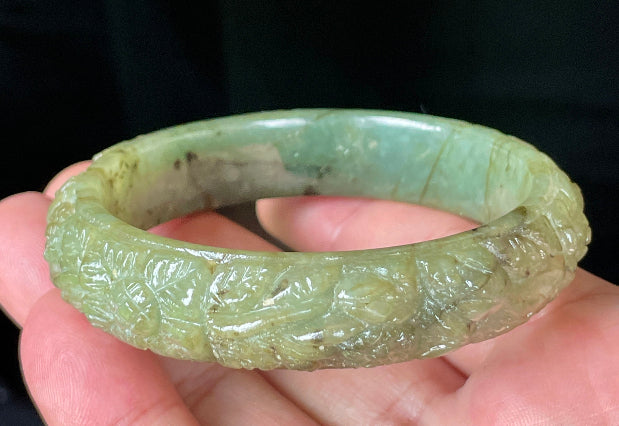 Solid icy apple green natural Type A Burmese jade bangle bracelet with carved floral design, size 58.3mm