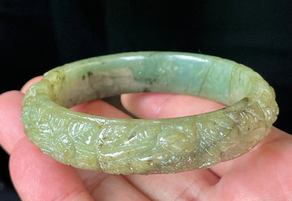 Solid icy apple green natural Type A Burmese jade bangle bracelet with carved floral design, size 58.3mm