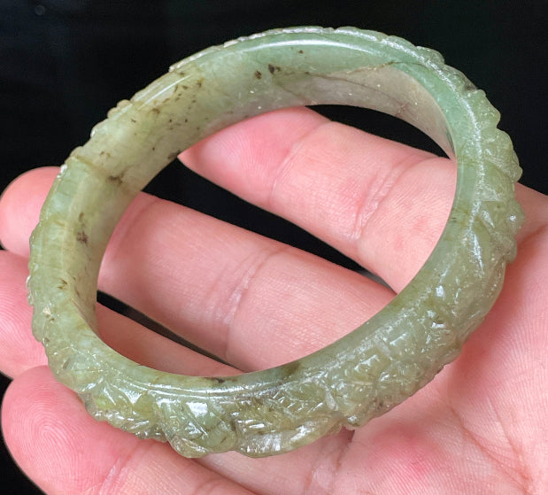 Solid icy apple green natural Type A Burmese jade bangle bracelet with carved floral design, size 58.3mm