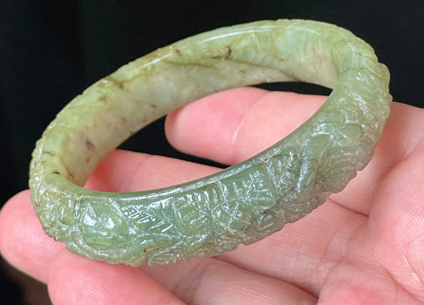 Solid icy apple green natural Type A Burmese jade bangle bracelet with carved floral design, size 58.3mm