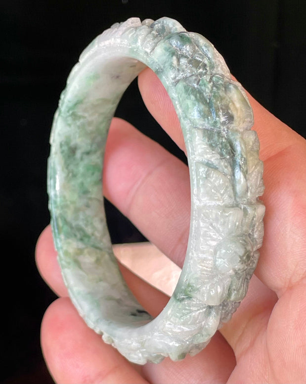 Solid icy emerald and imperial green natural Type A Burmese jade bangle bracelet with carved floral design, size 56mm