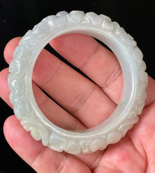 Solid icy translucent apple green natural Type A Burmese jade bangle bracelet with carved floral design, size 50.7mm
