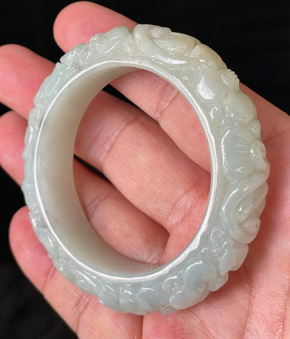 Solid icy translucent apple green natural Type A Burmese jade bangle bracelet with carved floral design, size 50.7mm