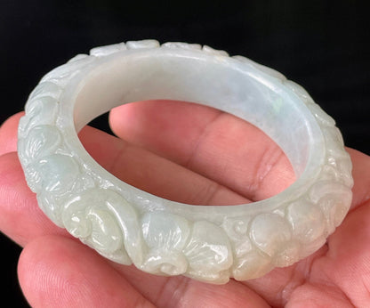 Solid icy translucent apple green natural Type A Burmese jade bangle bracelet with carved floral design, size 50.7mm