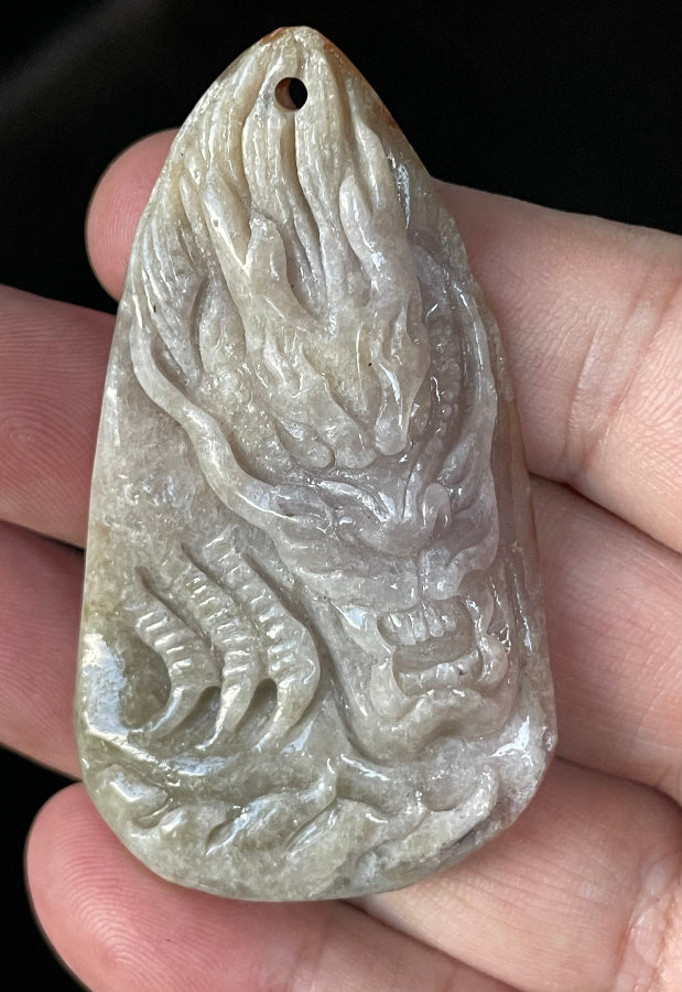 Untreated Type A Burmese jade pendant showing vitreous luster with beautiful greyish brown and orange colors on an adjustable red cord