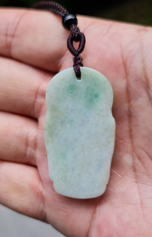 Untreated Type A Burmese jade pendant showing semi-translucent luster with beautiful icy green and soft lavender tones on an adjustable cord