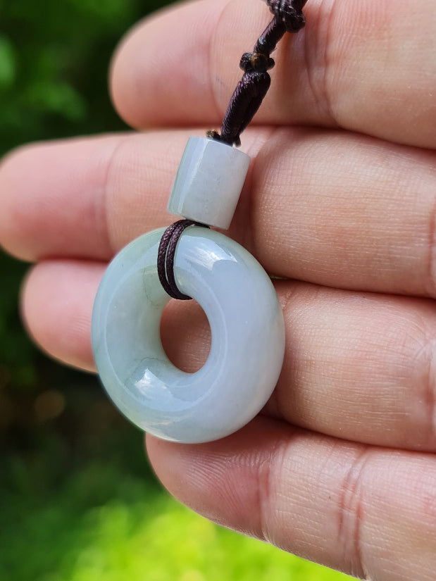 Untreated Type A Burmese jade pendant showing translucent luster with beautiful icy violet and soft green colors on an adjustable cord
