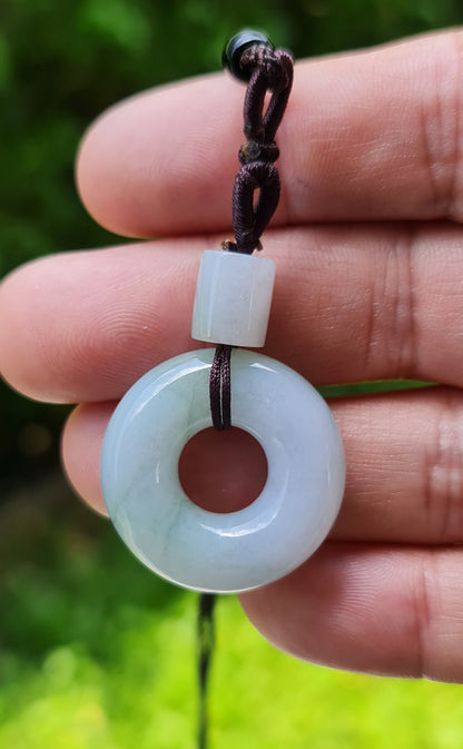 Untreated Type A Burmese jade pendant showing translucent luster with beautiful icy violet and soft green colors on an adjustable cord