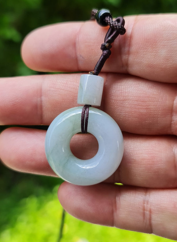 Untreated Type A Burmese jade pendant showing translucent luster with beautiful icy violet and soft green colors on an adjustable cord