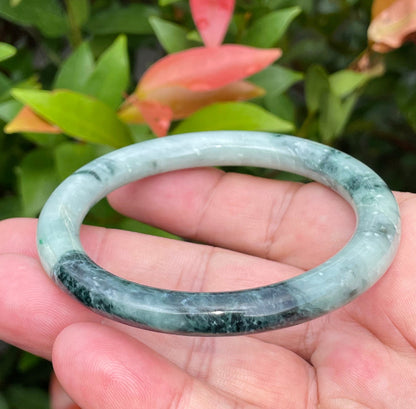 Handcrafted genuine Grade A Burmese jadeite bracelet showcasing a beautiful contrasting green and black appearance