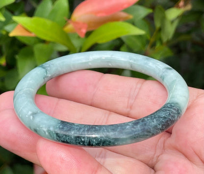Handcrafted genuine Grade A Burmese jadeite bracelet showcasing a beautiful contrasting green and black appearance