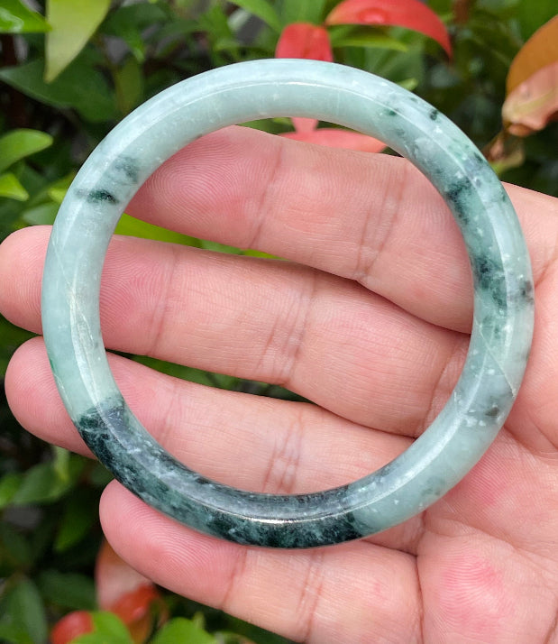 Handcrafted genuine Grade A Burmese jadeite bracelet showcasing a beautiful contrasting green and black appearance