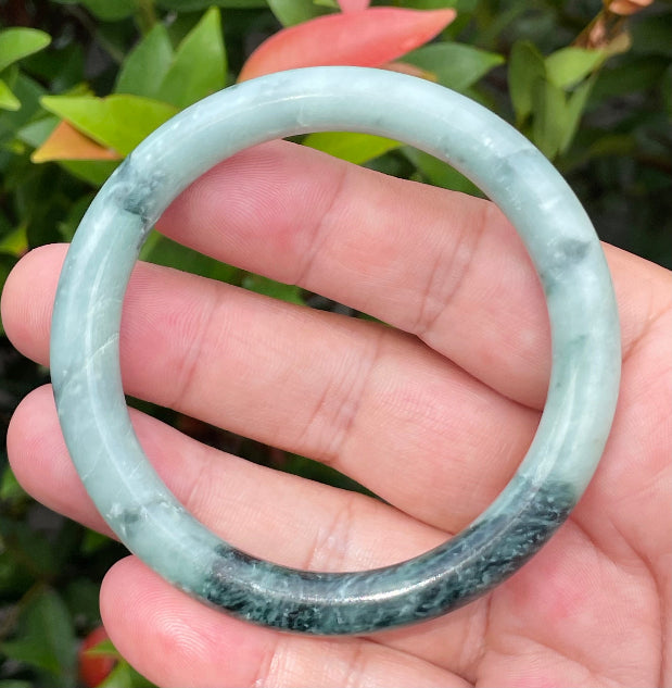 Handcrafted genuine Grade A Burmese jadeite bracelet showcasing a beautiful contrasting green and black appearance