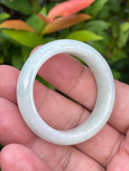 Handcrafted genuine Grade A Burmese jadeite infant bangle showcasing a translucent bright green appearance